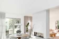 a double-sided fireplace clad with brick is a pretty and cozy space divider for the dining-living room zone