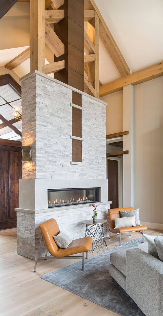 Living room with high beamed cathedral ceiling and two sided stone fireplace
