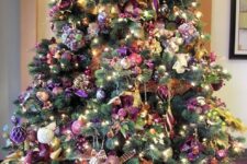 a gorgeous sophisticated Christmas tree with pink, purple, silver ornaments, plaid ribbons, beads and lights is fantastic