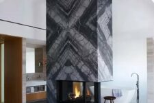 a luxurious marble fireplace that is a centerpiece of a room