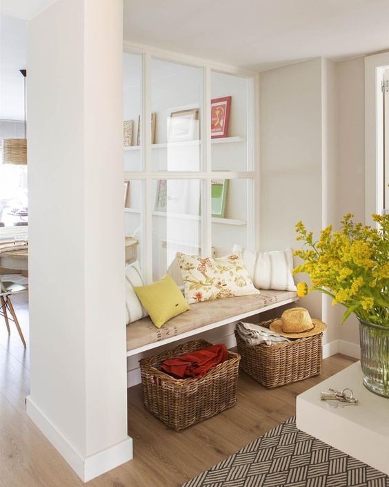 a large window from the living room to the entryway makes the little nook filled with natural light and makes it more welcoming