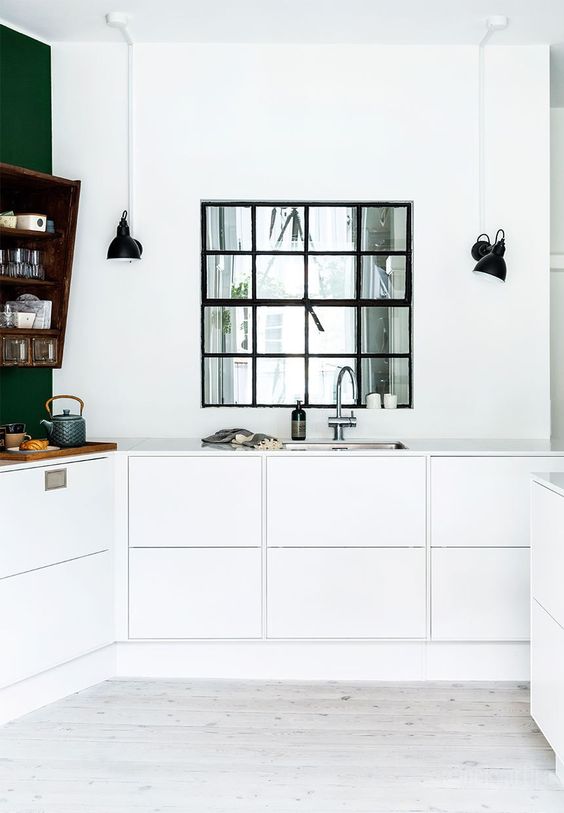 a minimalist white kitchen with a black frame window to the living room is a stunning idea for letting more light everywhere