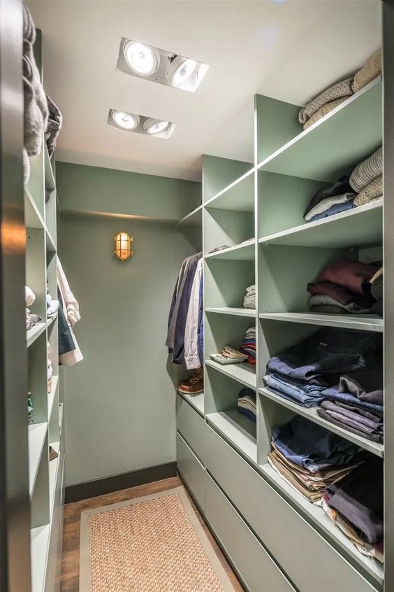 a mint green closet with shelves and drawers and built in lights is a stylish idea with a soft touch of color