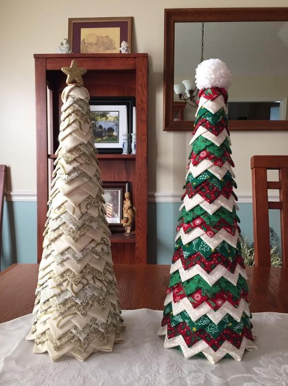 a neutral and green, red and white fabric piece cone-shaped Christmas trees, topped with a star and a pompom
