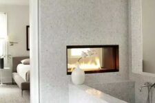 a cute neutral bathroom with a fireplace