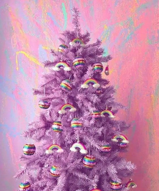 a purple Christmas tree decorated with rainbows and rainbow baubles is a lovely and super bold idea