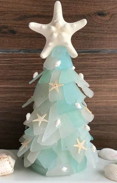a seaglass cone Christmas tree decorated with little shells and starfish and topped with a starfish is a great decoration for a coastal Christmas space