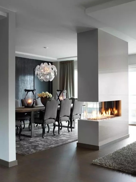 a sleek white minimalist double sided fireplace will give a chic look to the space and make it cozy