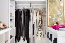 a small and glam closet in white, with built-in shelves and wardrobes, with an open storage cabinet and a glam crystal chandelier