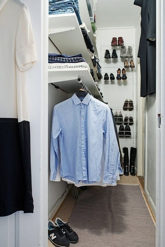 a small and narrow closet in white, with open shelves and railing, shoe shelves attached to the wall is a lovely idea for a small home