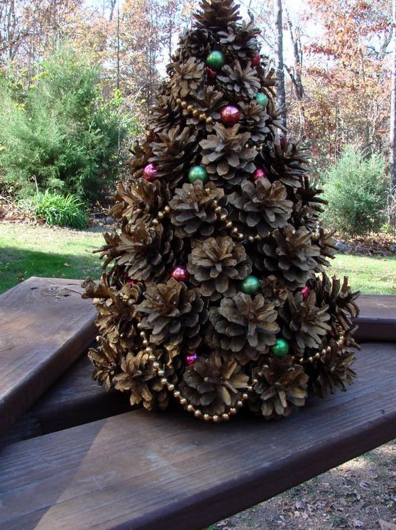 a small pinecone Christmas tree decorated with colorful beads is a cute rustic decoration