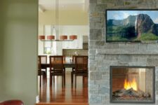 a stone clad double-sided fireplace is a nice idea for both the dining space and the living room is amazing