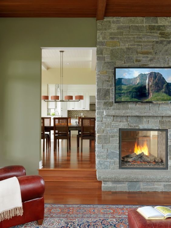 a stone clad double-sided fireplace is a nice idea for both the dining space and the living room is amazing