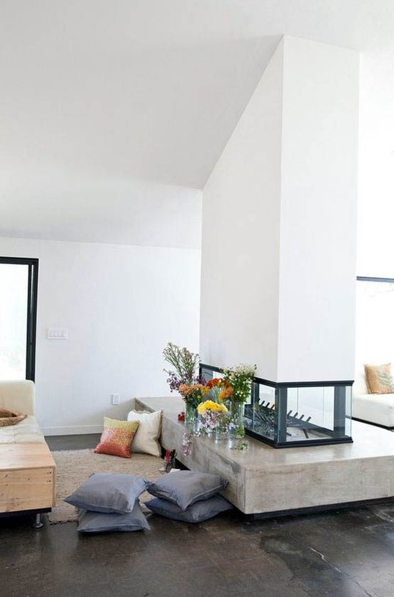 a stylish white double-sided fireplace with a glass part and a concrete one is a chic idea for a contemporary home