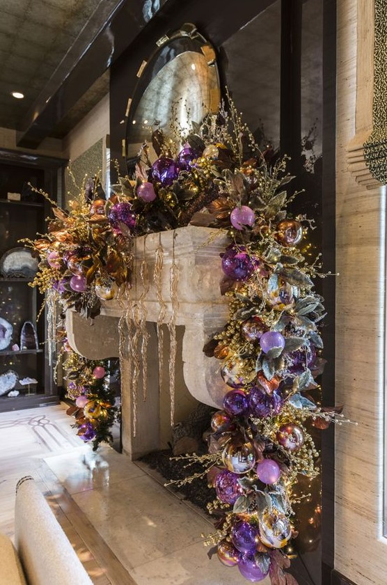 a super lush and refined garland with lilac, purple, silver and gold ornaents, beads and lights is a gorgeous way to dress up a mantel