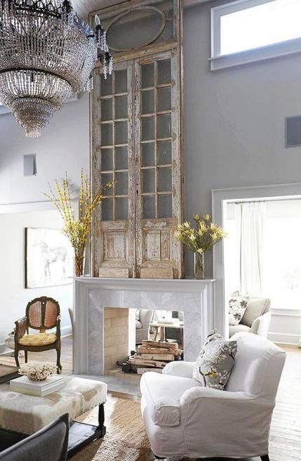 a vintage meets shabby chic space with a marble clad double sided fireplace is a welcoming home with plenty of coziness