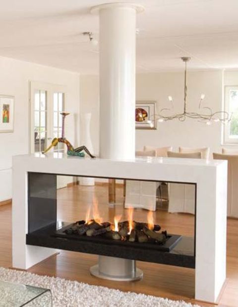 a white double-sided fireplace of glass is a lovely idea for a dining or living room and is a stylish addition to both spaces