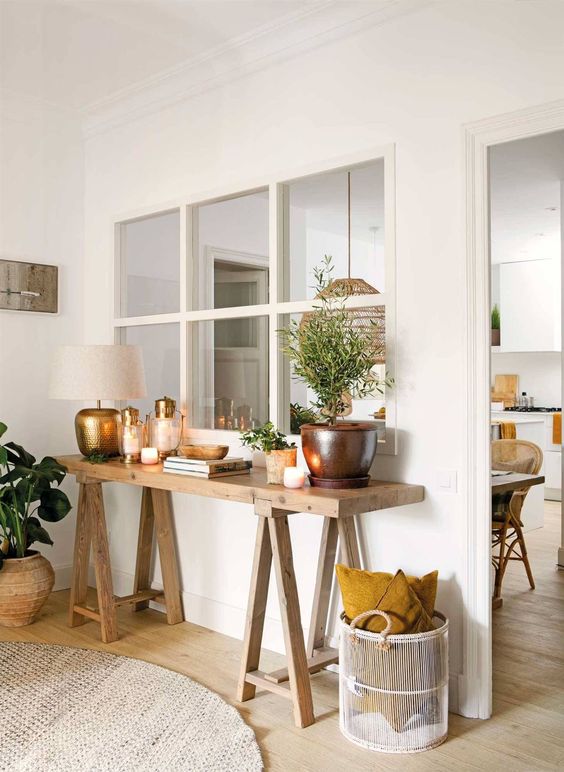 a window from the kitchen and dining room to the living room connects both spaces and gives them both natural light