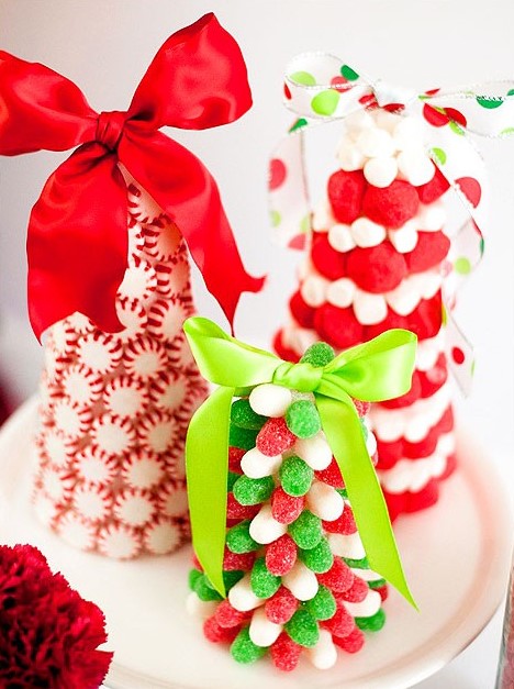 an arrangement of gorgeous red, green and white candy Christmas trees topped with large bows are perfect for celebration