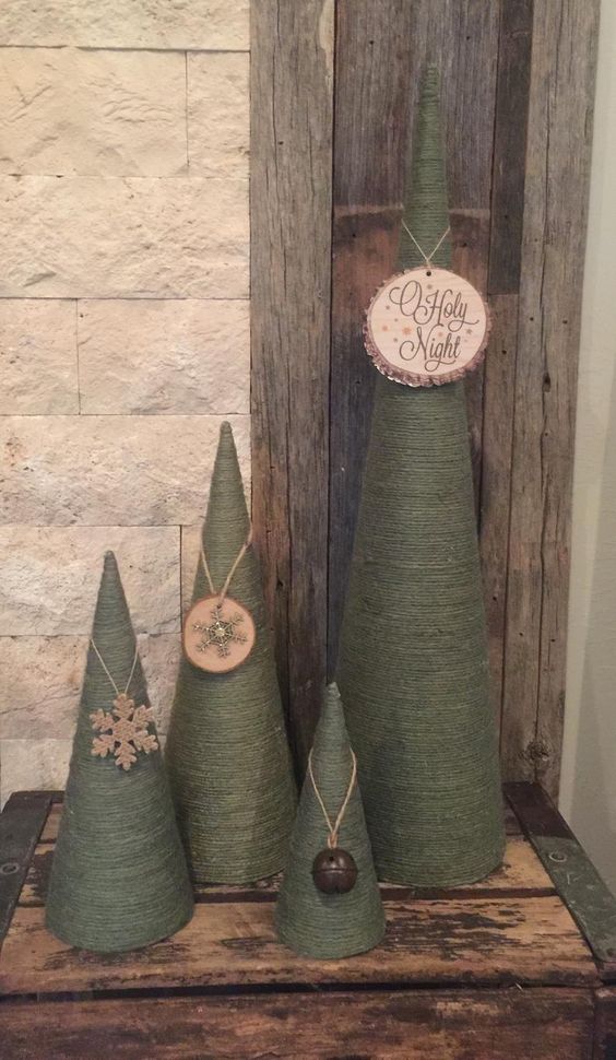 cool green rope cone shaped Christmas trees decorated with branch slices, snowflakes and bells are amazing for holiday decor