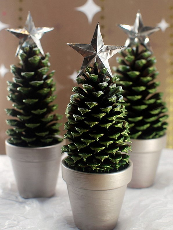 large pinecones painted green, in silver planters and topped with silver stars are great alternative tabletop Christmas trees