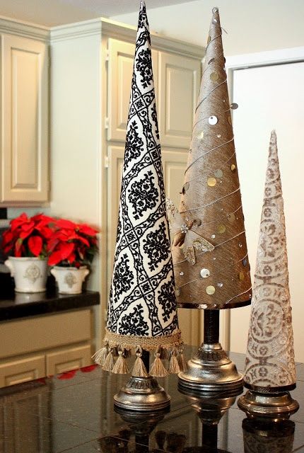 printed paper cone Christmas trees with tassels, coins, rhinestones, on metallic stands are nice for eclectic winter decor