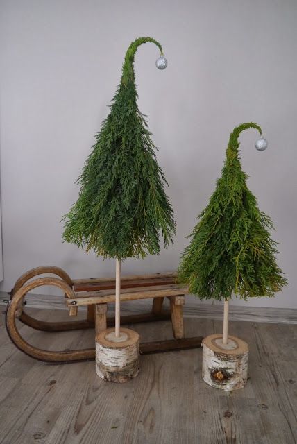 rustic cone-shaped Christmas trees topped with ornaments and on tree cut stands are amazing for rustic and fairy tale holiday decor