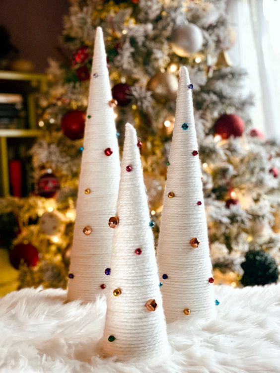 very easy Christmas decor - white yarn wrapped cones decorated with bold bells and beads that are super cool