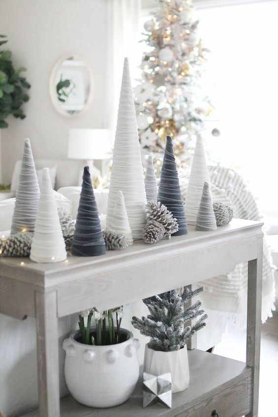 white, grey and graphite grey velvet cord cone Christmas trees styled with LED lights and snowy pinecones