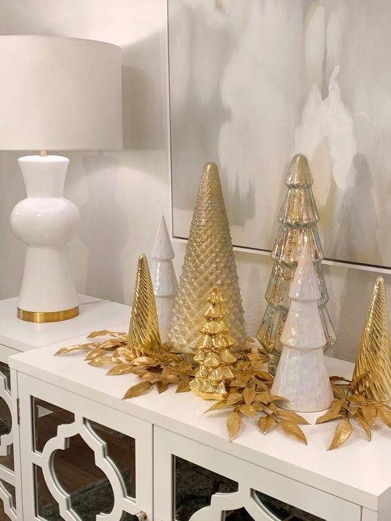 white, silver and gold cone-shaped Christmas trees and gilded leaves are great for styling a console or a mantel