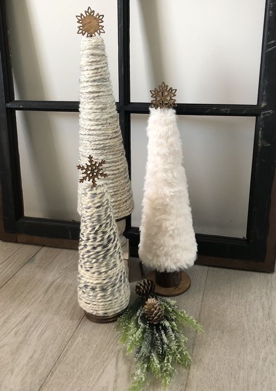 yarn and faux fur cone-shaped Christmas trees topped with wodoen snowflakes will be a nice idea for a rustic space