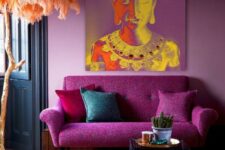 03 a vibrant magenta living room with a magenta sofa and bold pillows, a side table, a colorful rug and a brigth print looks very whimsical