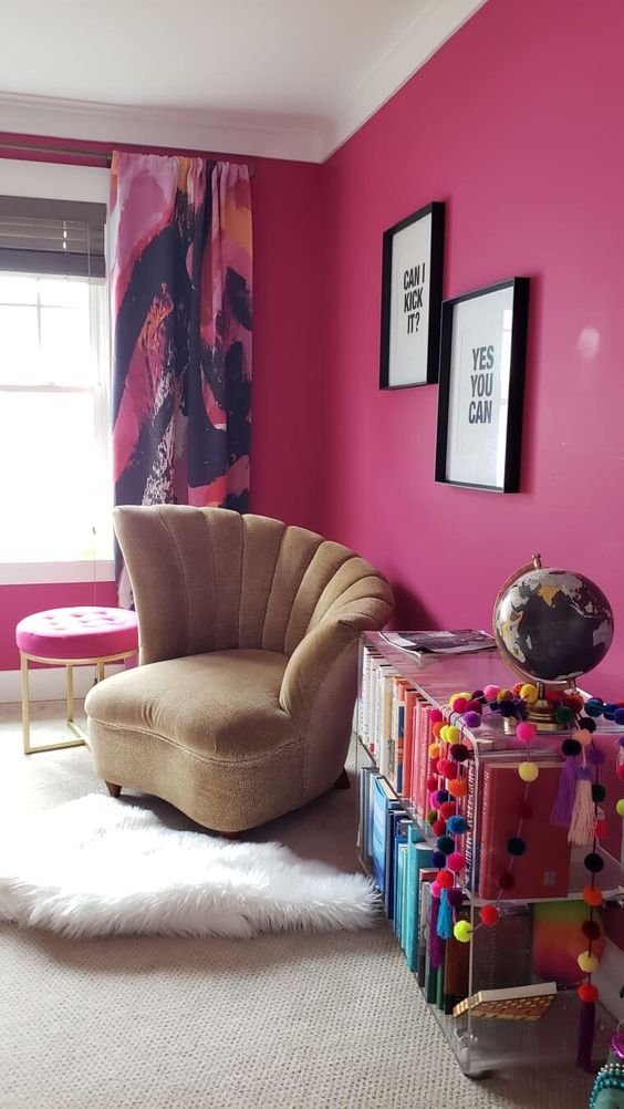 a bright magenta home office with bold curtains, a neutral chair, an acrylic storage unit, layered rugs and a hot pink stool