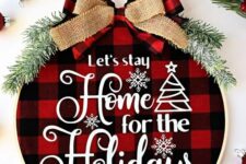 04 a cozy Christmas wreath with red plaid fabric, white letters, evergreens and a couple of bows on top is amazing