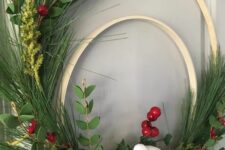 05 a double embroidery hoop Christmas wreath of evergreens, berries, snowy pinecones, a bird and a ribbon bow is lovely