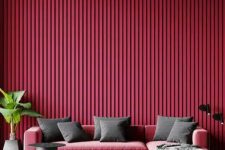 06 a gorgeous magenta living room with a pink low sofa, grey pillows, a potted plant and a side table is amazing