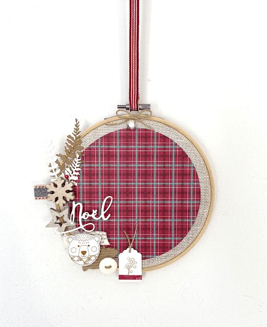 a lovely Christmas wreath made of an embroidery hoop, plaid fabric, wooden stars, snowflakes, tags and leaves is perfect for a rustic space