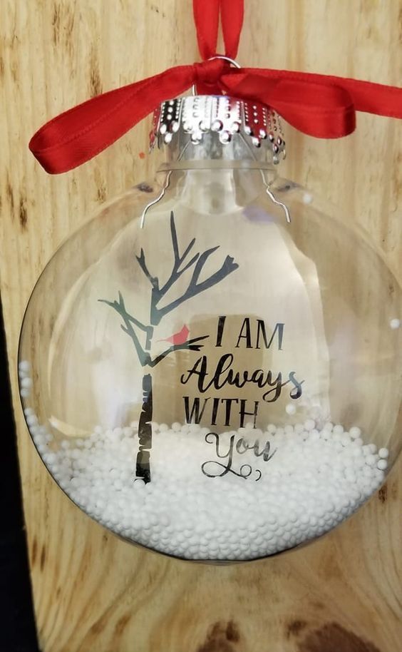 a clear glass Christmas ornament with faux snow, some stenciling and a large red bow is a lovely idea for the holidays