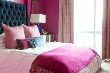 09 a magenta bedroom with a bed with a teal headboard, a chandelier, light pink curtains and a colorful rug is amazing