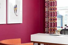 11 a magenta home office, a white desk, a black chair, an orange one, a printed rug and crutains for a bold look