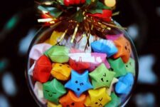 14 a fun Christmas ornament filled with colorful origami stars and topped with faux greenery and berries