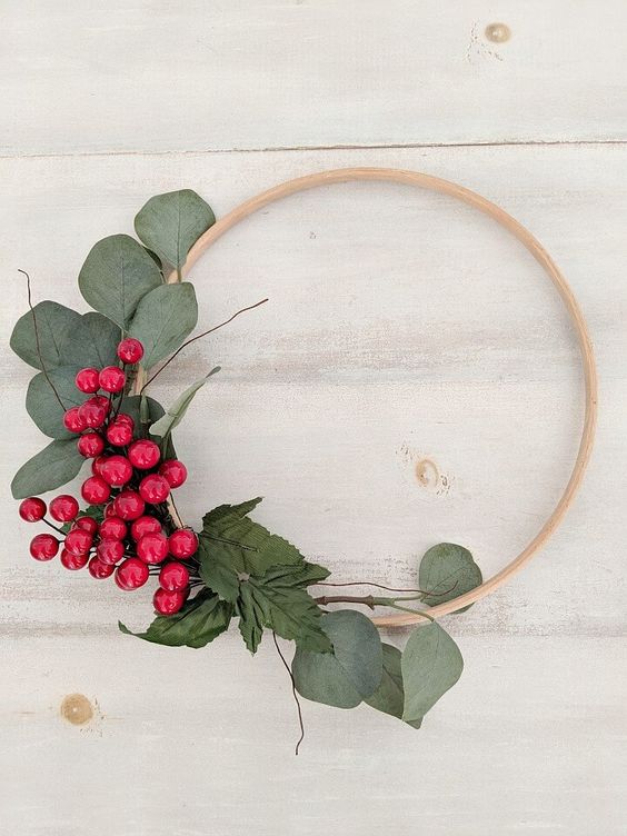 a simple and quick to make Christmas wreath decorated with greenery and bold red berries is a lovely decoration