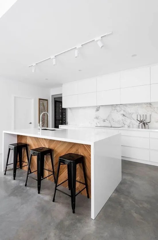 sleek white cabinets and a white marble backsplash that makes the whole space very exquisite and edgy