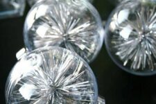 19 clear glass Christmas ornaments filled with silver tinsel are a simple and quick to realize idea for the holidays