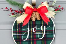 20 a super cool and easy to make Christmas wreath with green plaid, a red and neutral ribbon bow on top, evergreens and berries