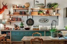 20 a vintage rustic kitchen with teal and stained cabinets, a stained dining set with vintage chairs, open shelves and an orange faux taxidermy piece