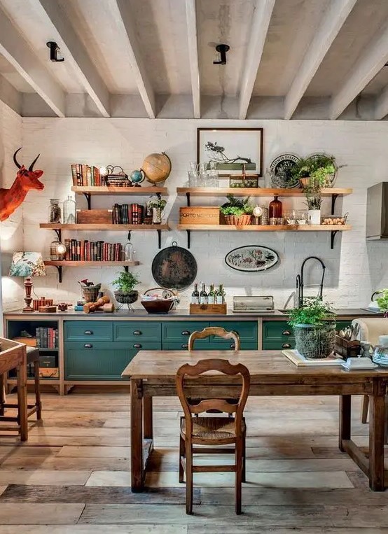 a vintage rustic kitchen with teal and stained cabinets, a stained dining set with vintage chairs, open shelves and an orange faux taxidermy piece