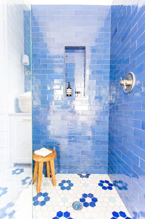bright blue tiles and hex ones with blue floral accents that highlight the color of the walls