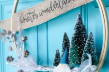 23 an embroidery hoop Christmas wreath with bottle brush trees, a burlap ribbon and snowy pinecones is cool