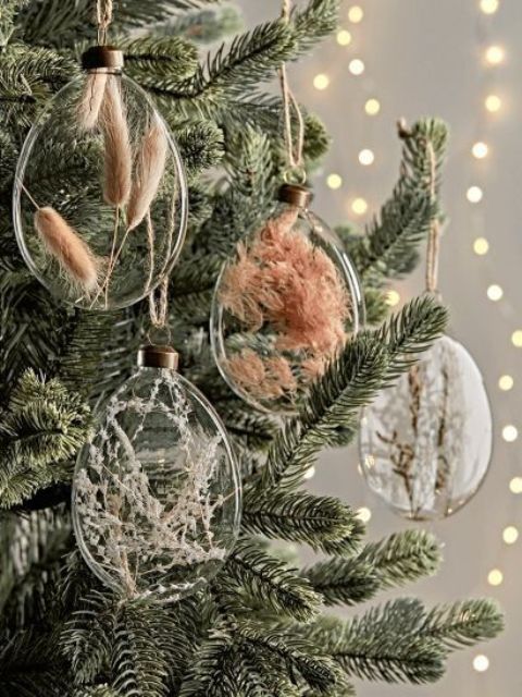 clear glass ornaments filled with dried grasses and blooms are amazing for boho Christmas decor